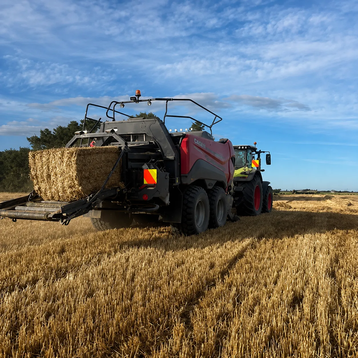 Big square baler working through stubble