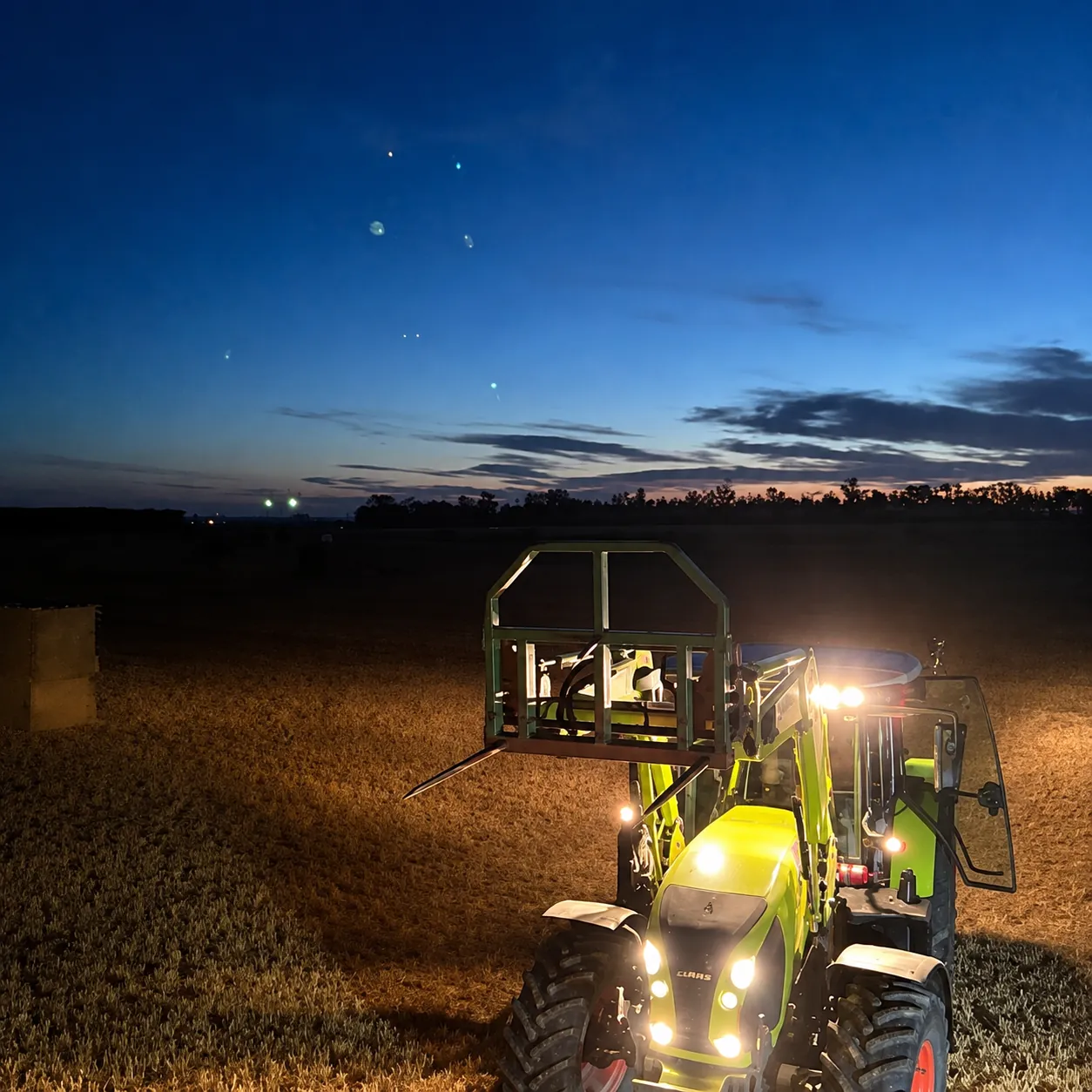 Baling under lights at night