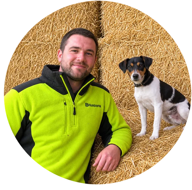 Andrew Harris with his dog on the straw
